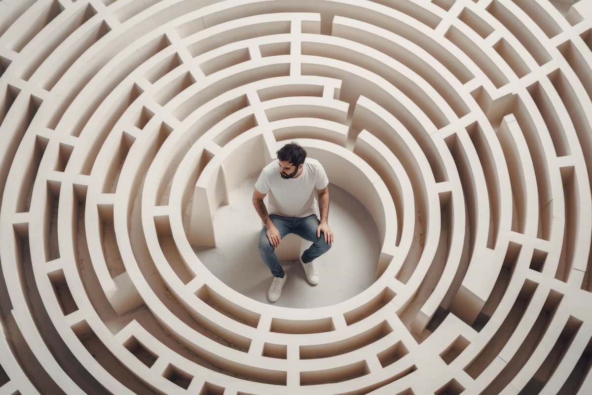 man in the middle of a maze looking confused