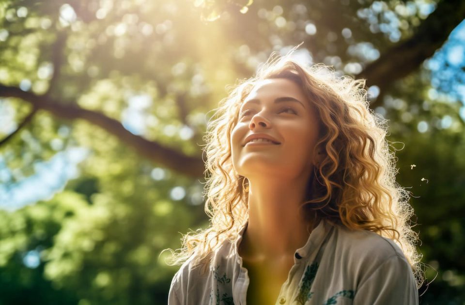 Young woman in the park in the morning, looking high up