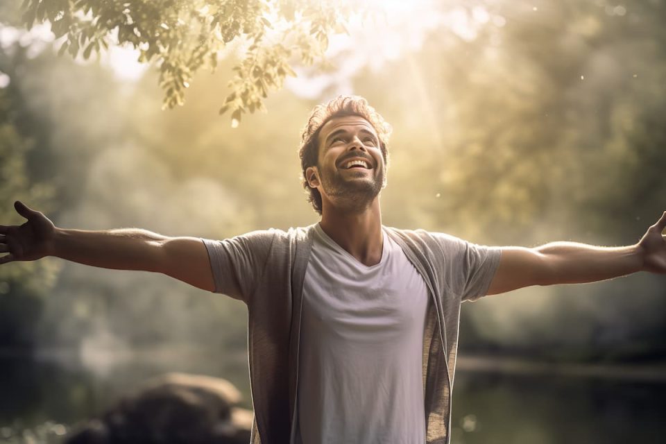 a happy man with his arms raised in the air