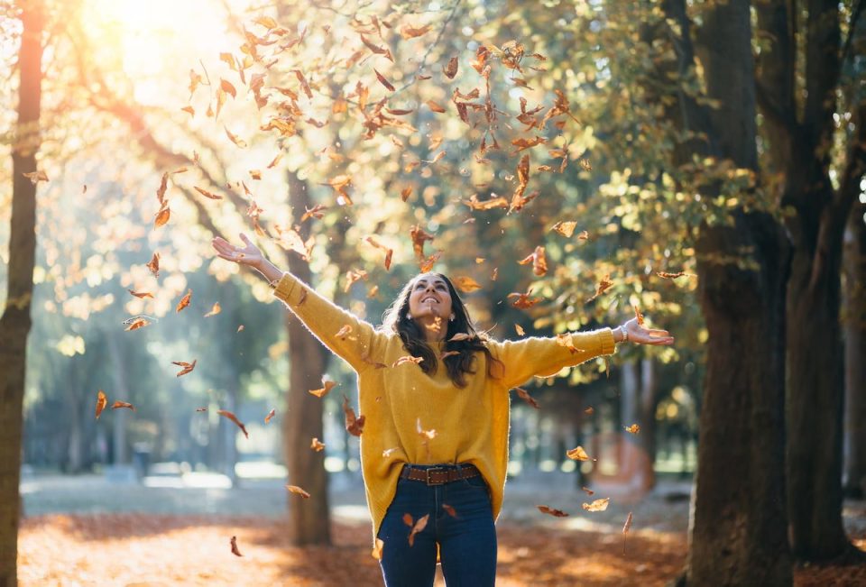 happy woman enjoying nature in the fall