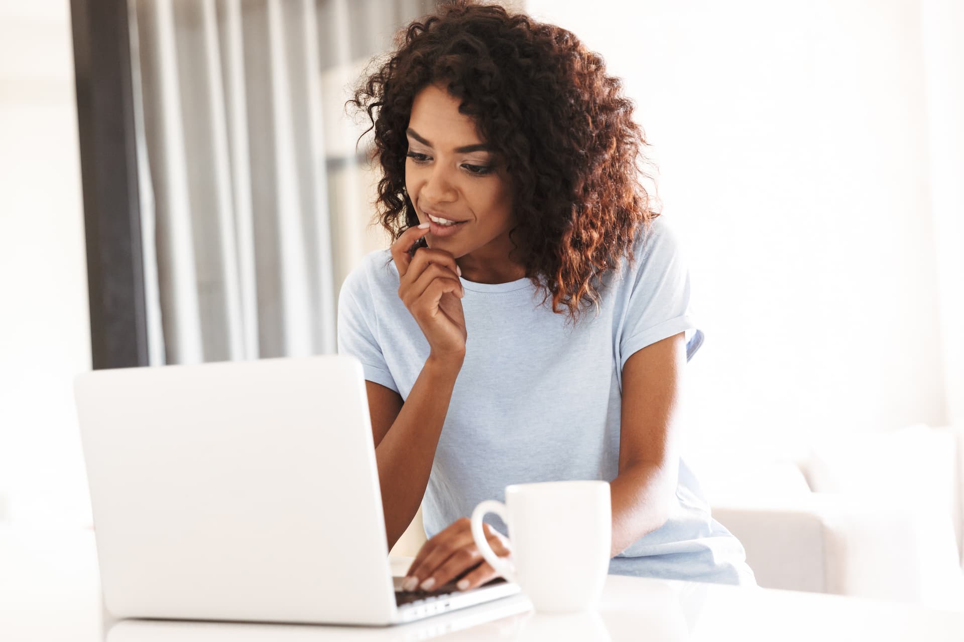 curious woman reading from laptop